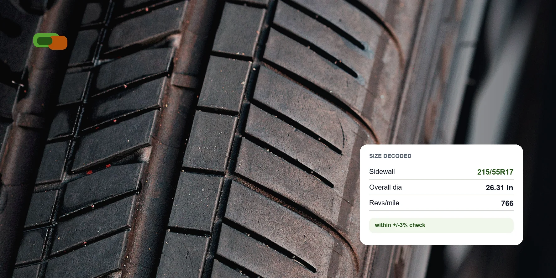 Close-up tire tread with a TreadSize measurement card showing decoded tire dimensions
